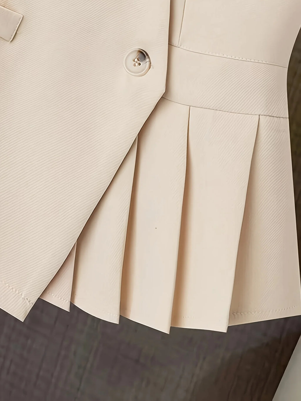 Women’s clothing featuring a V-neck, sleeveless design with pleats at the hem. Perfect for casual or professional settings with