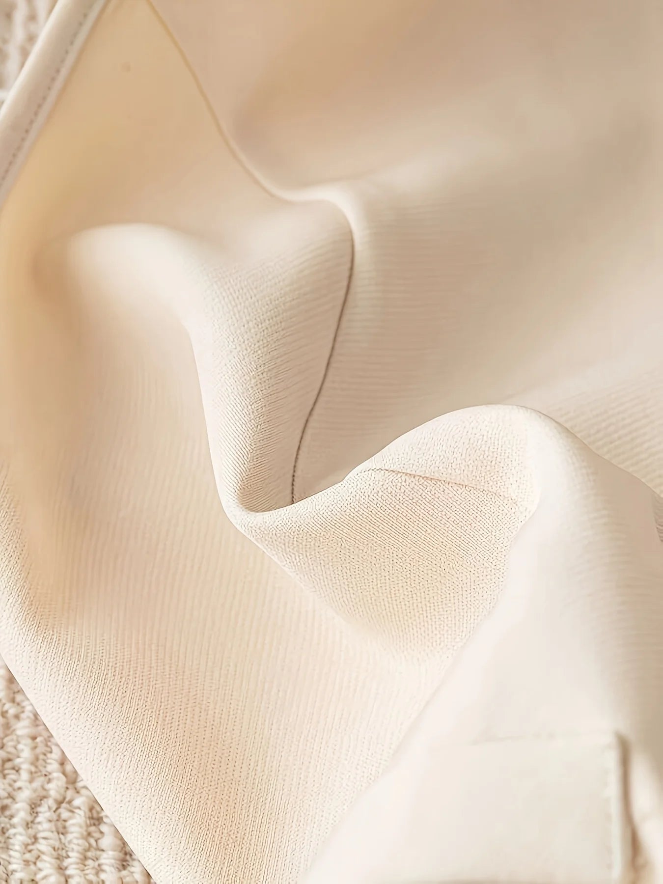 Women’s clothing featuring a V-neck, sleeveless design with pleats at the hem. Perfect for casual or professional settings with